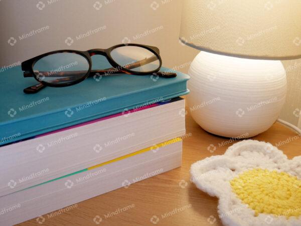 Bedside table with books and glasses