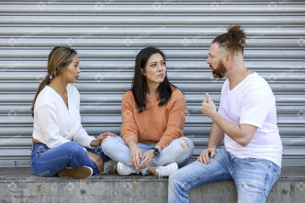 Three people sitting and talking outside – Mindframe online image ...