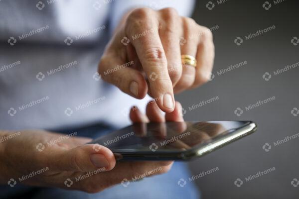 Close up of hands, using a phone