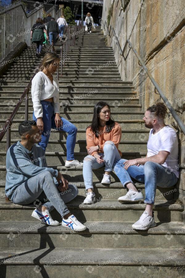 Four people talking on a set of stairs