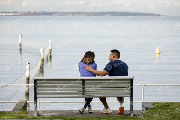 Two people sitting on a bench