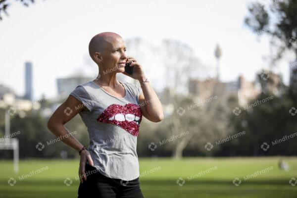 One person, walking looking at their phone