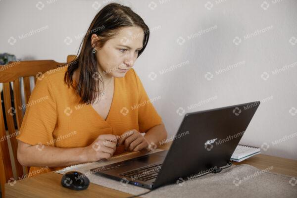 One person working on computer at home