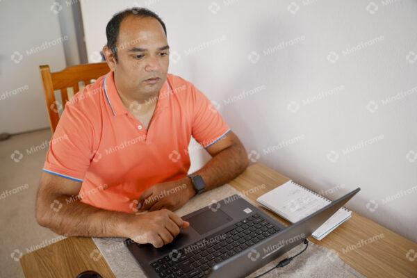 One person working on computer at home